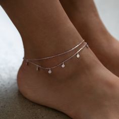 Dress up plain pumps or flats with this chic anklet featuring dangling polished discs on a layered chain. .925 Sterling Silver 4mm Discs Hypoallergenic, lead, and nickel free Length: 9in (22cm) + Extension: 1in (2.5cm) Lobster clasp closure Handcrafted in NYC #ANK014 Aesthetic Silver Anklets, Silver Anklet Aesthetic, Minimal Anklet, Body Decor, Crystal Anklet, Silver Anklet, Layered Chain, Awesome Tattoos, Sterling Silver Anklet