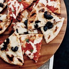 several slices of pizza on a wooden platter