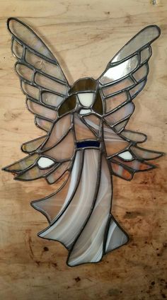 a stained glass angel on a wooden surface