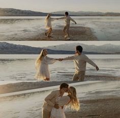 two people holding hands on the beach with mountains in the background