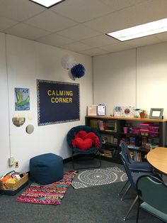 an office cubicle with two chairs and a sign on the wall that says calming corner