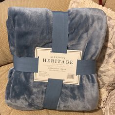 a blue blanket sitting on top of a couch