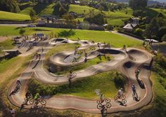 an aerial view of people riding their bikes around a skate park with ramps and ramps