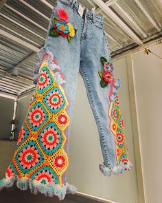 the jeans are decorated with flowers and beads