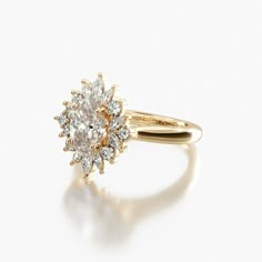 a yellow gold and white diamond ring on a white background, with the center stone surrounded by smaller diamonds