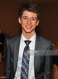 a young man wearing a suit and tie