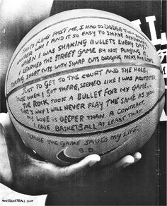 a person holding a basketball in their hand with words written on it and writing on the ball