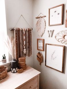 a white room with pictures hanging on the wall and other items in front of it