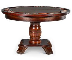 a round wooden table with an intricately carved top