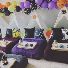 two beds with halloween decorations and balloons on the wall