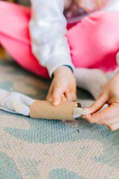 a child is playing with an object on the floor