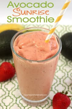 a smoothie with strawberries and avocado in the background