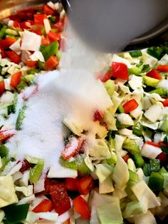 the food is being mixed together in a bowl