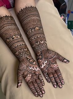 two hands with henna designs on them