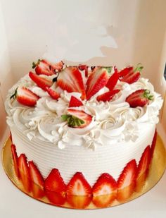 a birthday cake with white frosting and strawberries