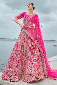 Make your wedding unforgettable with our Ruby Reach Color Pure Silk Heavy Embroidered Bridal Lehenga Choli With Double Dupatta. This stunning ensemble is made from luxurious pure silk and boasts detailed embroidery work, making it perfect for a bridal statement. The set includes two matching dupattas: one heavy for traditional wear and one lighter for modern aesthetics. Each piece in this bridal attire promises to deliver a regal feel and ensures all eyes are on you as you walk down the aisle. Double Dupatta, Silk Bridal Lehenga, Embroidered Bridal Lehenga, Bridal Lehenga Online, Pink Lehenga, Ghagra Choli, Designer Lehenga, Designer Lehenga Choli