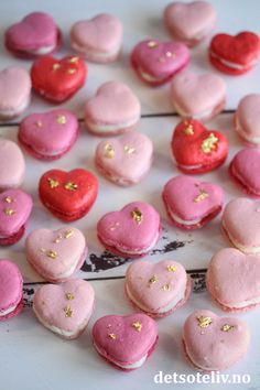 there are many heart shaped macaroons on the table