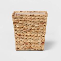 a small basket with a handle on the front and bottom, made out of wicker