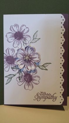 a handmade card with purple flowers on the front and white border around the edges