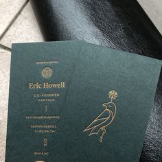 a close up of a green and gold colored paper with a bird on it's back