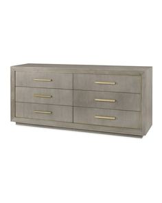 a grey dresser with gold handles and drawers