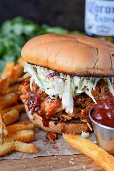 slow cooker bbq chicken sandwich with coleslaw and fries on the side