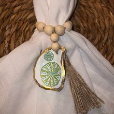 a beaded necklace with a green and white design on it sitting next to a bag