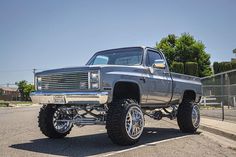 a silver truck parked on top of a parking lot