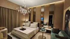 a hotel room with a bed, couch and chandelier