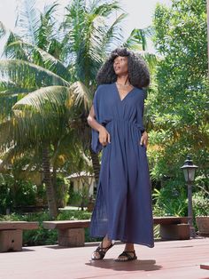 Introducing our Acacia Cotton Linen Goddess Dress in navy, a stunning addition to our Goddess Collection. This dress is lovingly handcrafted with 100% cotton-linen and is ideal for both casual beach days and elegant nights out. The elastic waistband and bat-wing sleeves offer a feminine, bohemian style, while the lightweight fabric and two side pockets ensure comfort and versatility. Plus, the self-belt highlights the waist for a flattering touch. Features: Soft cotton linen-blend, no lining Ela Chic Cotton Maxi Dress For Beach Cover-up, Cotton V-neck Beach Dress For Day Out, Navy V-neck Vacation Dress, Blue Linen Dress For Day Out, Blue Linen Summer Dress For Vacation, Indigo V-neck Summer Dress, Blue Linen Summer Dress For Day Out, Blue Linen Dress For Summer Day Out, Blue Linen V-neck Dress For Vacation