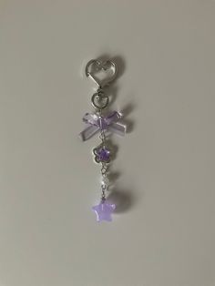 a keychain with a heart, star and crystal beads hanging from it's side