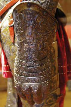 an elaborately carved wooden horse with red and gold accents on it's body