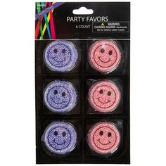 four party favors with smiley faces on them