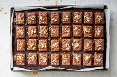 a pan filled with brownies covered in nuts