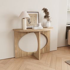 a wooden table sitting in the middle of a living room next to a chair and lamp