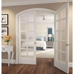 an open white door leading to a bedroom