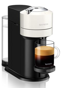 an espresso machine with a cup of coffee next to it