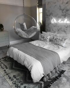 a bedroom with a hanging chair and bed