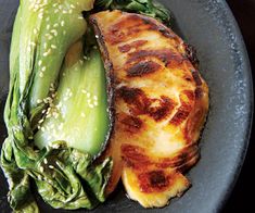 a close up of a plate of food with broccoli and fish on it