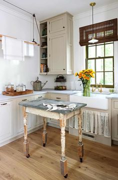 the kitchen is clean and ready to be used for cooking or baking, as well as flowers on the table