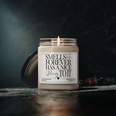 a candle is sitting on a table with the words smells of forever has since to it