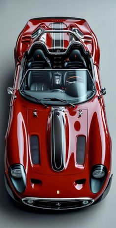 an old red sports car with its hood up and the engine compartment open, on a gray background