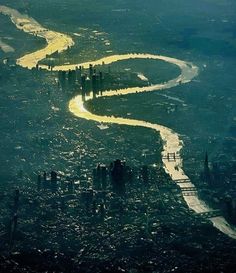 an aerial view of a river running through a city