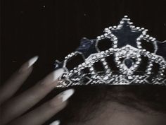 a close up of a person wearing a tiara