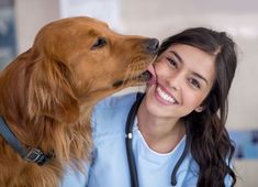 a woman with a stethoscope kissing a dog