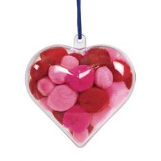 a heart shaped ornament filled with pink and red hearts