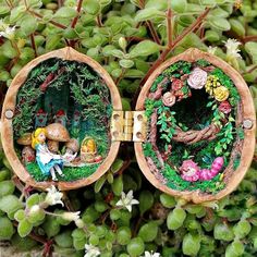 two miniature fairy garden scenes in wooden bowls on top of green plants with flowers around them