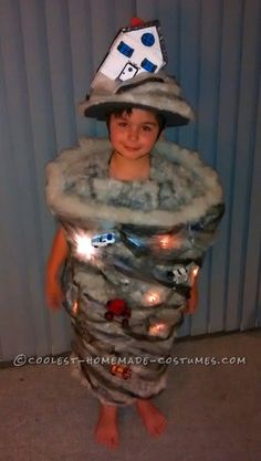 a young boy wearing a costume made to look like a rocket ship with lights on his head