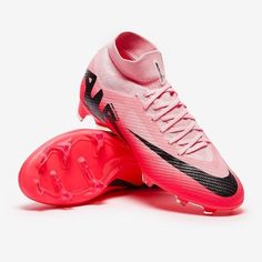 a pair of pink and black soccer shoes