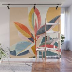 an abstract painting on the wall in a living room with wooden floors and white walls